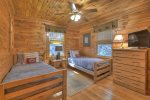 Main floor bedroom offers two twin beds and a flat screen tv streaming only 